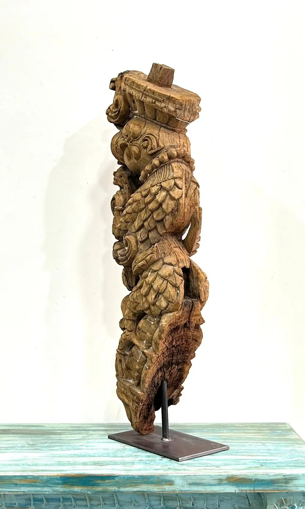 vintage hand-carved wooden bracket on iron stand