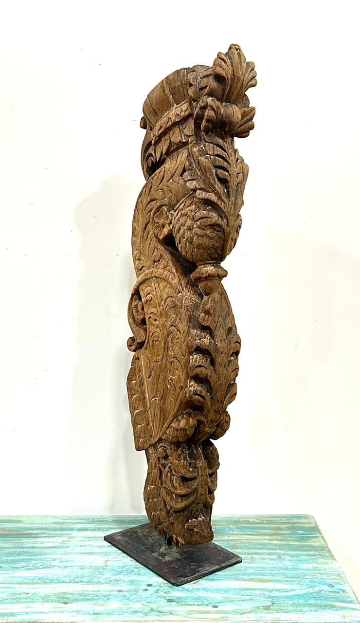 vintage hand-carved wooden balcony bracket mounted on iron stand | antique decorative piece
