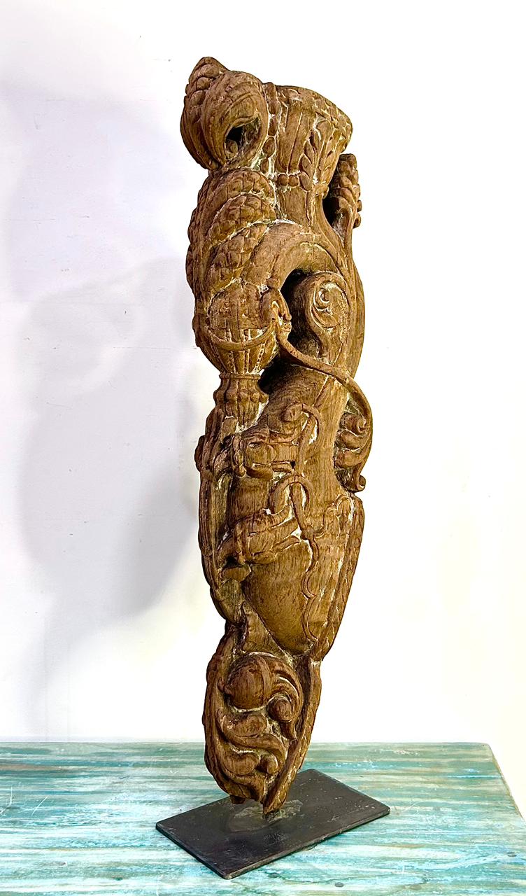 vintage hand-carved wooden balcony bracket on iron stand | antique architectural decor