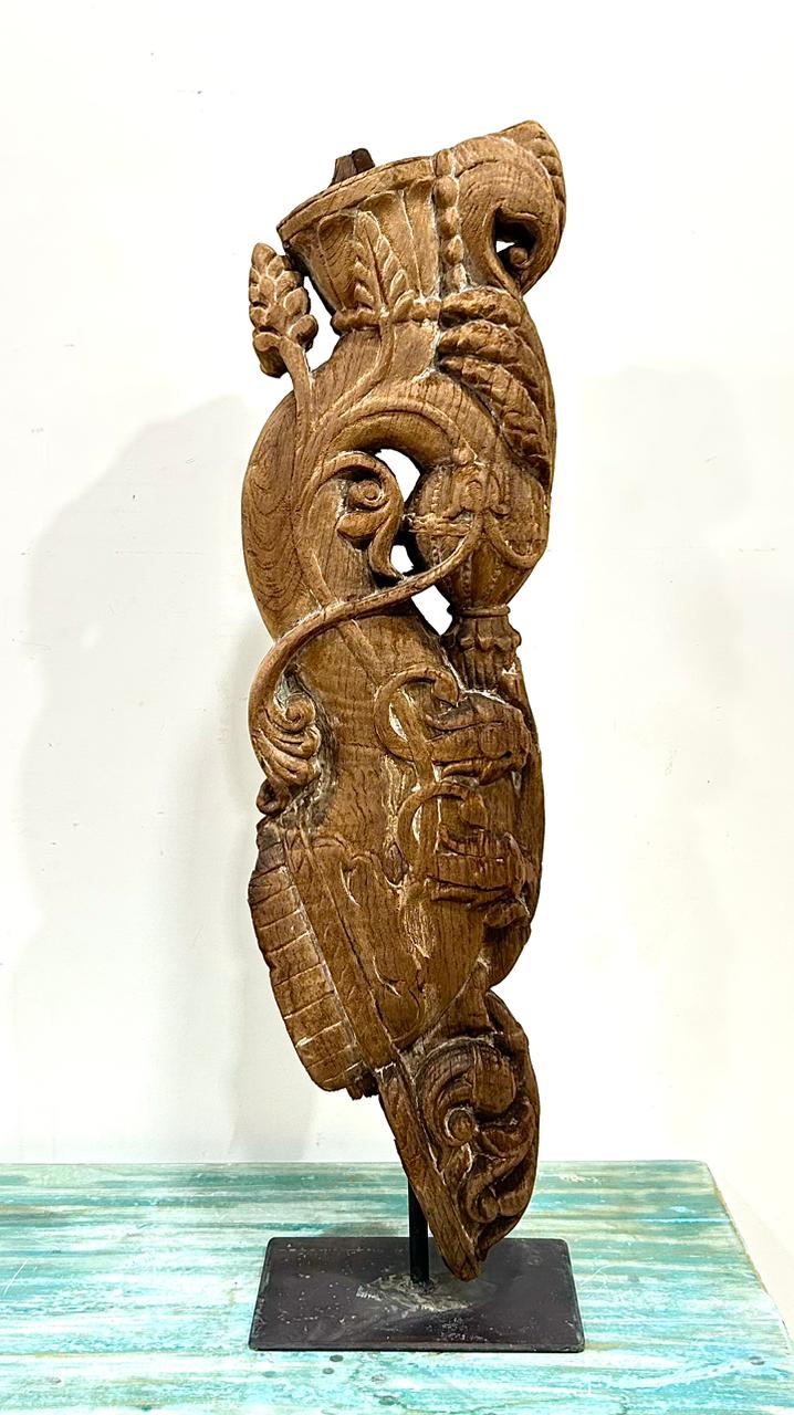 vintage hand-carved wooden balcony bracket on iron stand | antique architectural decor