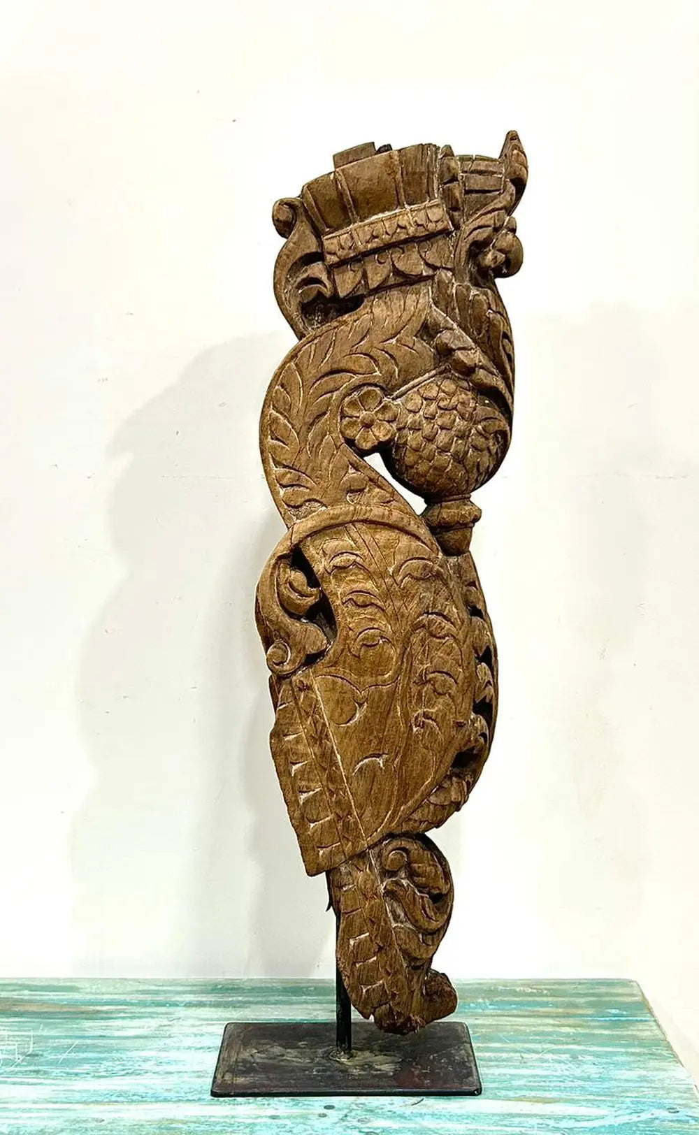 vintage hand-carved wooden balcony bracket mounted on iron stand | antique decorative piece