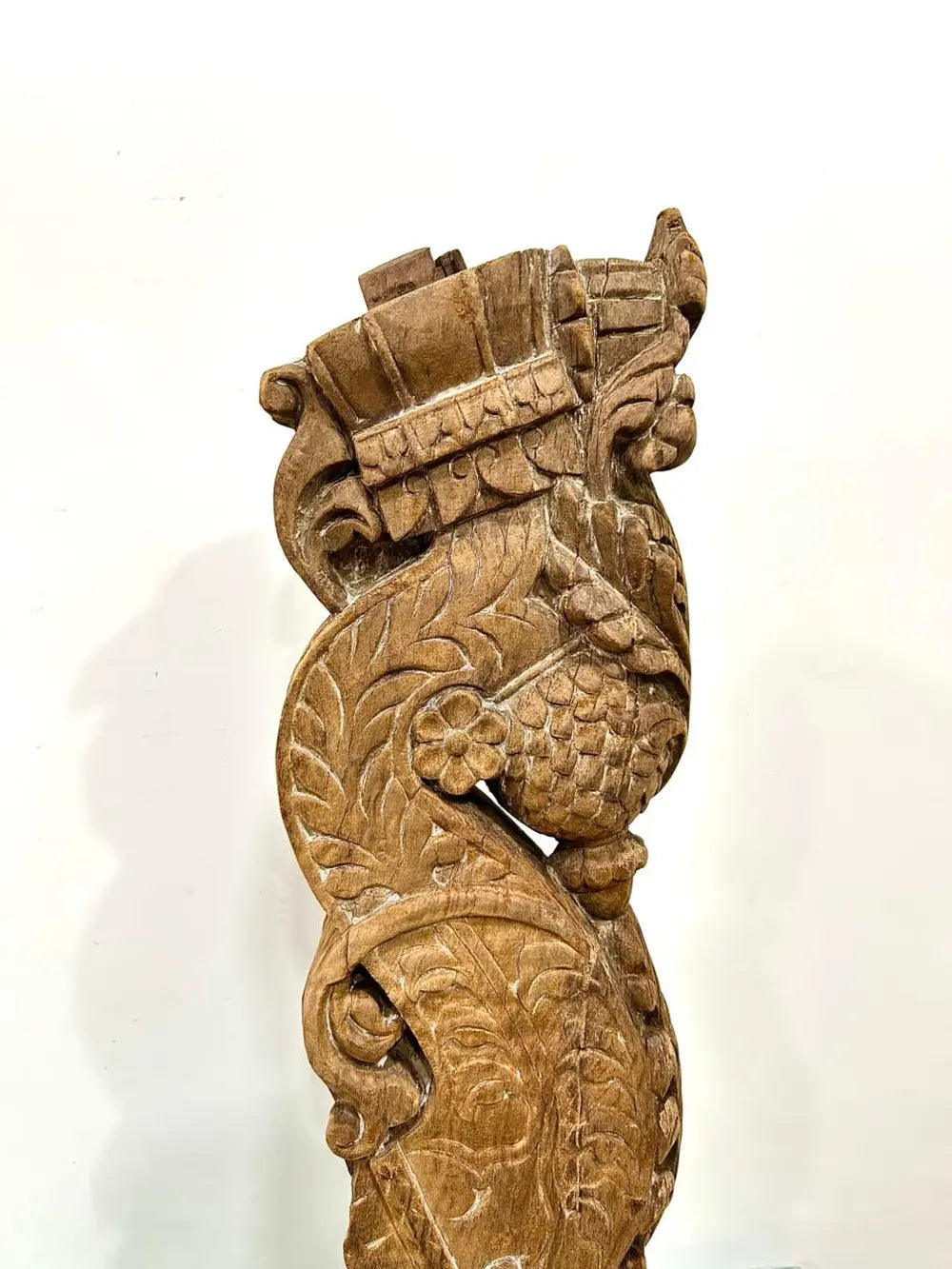 vintage hand-carved wooden balcony bracket mounted on iron stand | antique decorative piece