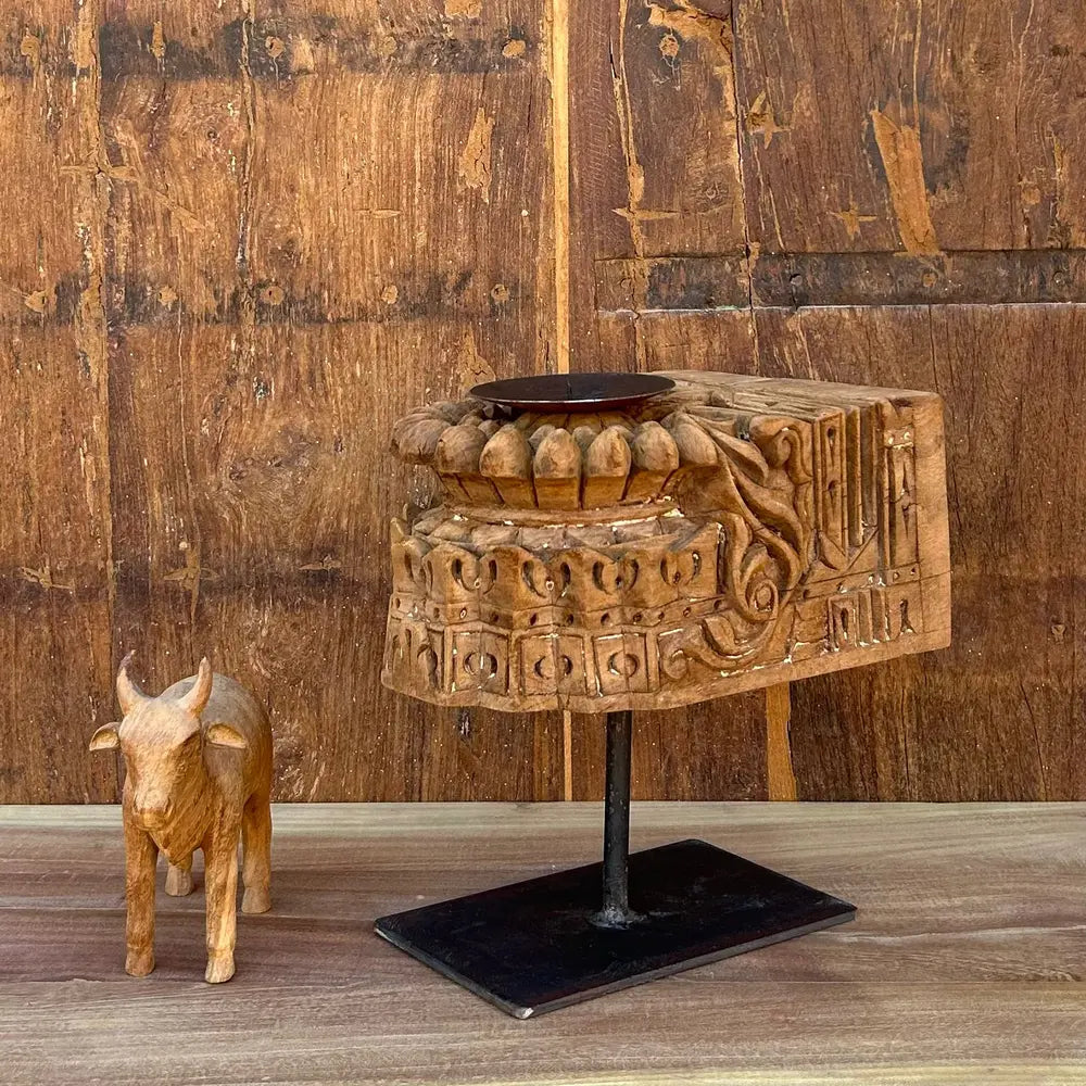 vintage hand-carved wooden candle holder on iron stand