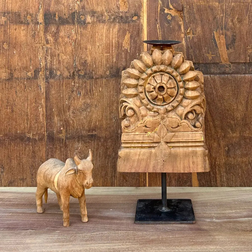 vintage hand-carved wooden candle holder on iron stand
